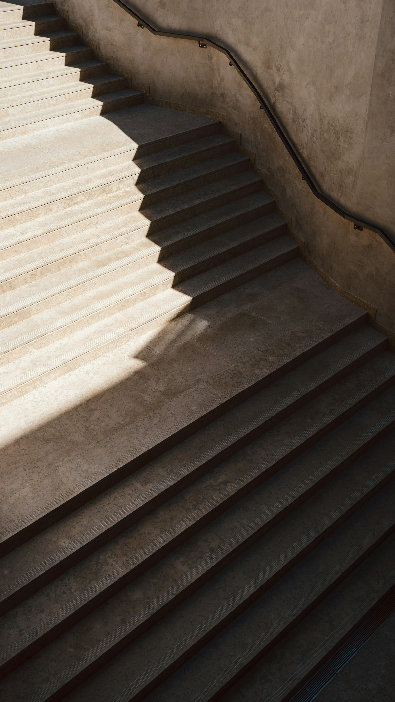Light and shadow across a concrete staircase